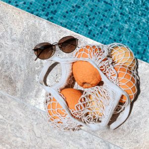 silver travertine paver and coping surrounding a pool with summer vibes