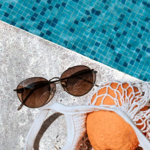 silver travertine paver and coping surrounding a pool with summer vibes