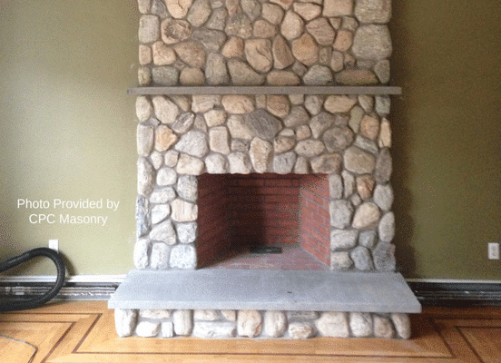 Photo of Cedar Creek River Rounds Natural Stone installed on a fireplace surround.