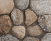 Photo of Cedar Creek River Rounds Natural Stone swatch showcasing rounded stones with natural tan, brown, and grey color variation.