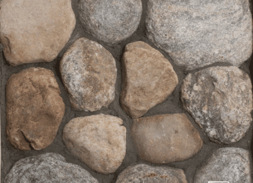 Photo of Cedar Creek River Rounds Natural Stone swatch showcasing rounded stones with natural tan, brown, and grey color variation.