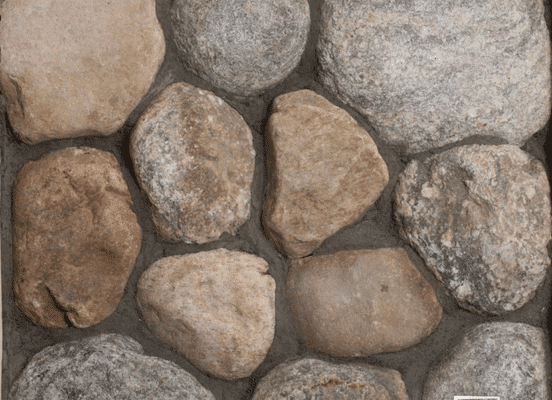 Photo of Cedar Creek River Rounds Natural Stone swatch showcasing rounded stones with natural tan, brown, and grey color variation.