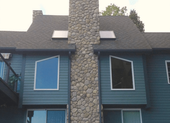 Photo of Cedar Creek River Rounds Natural Stone installed on an exterior home facade.