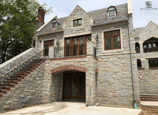 Photo of Dusty Rose Square and Rectangle Natural Thin Stone Veneer installed on the exterior facade of a luxury home.