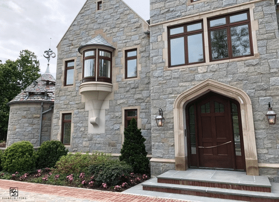 Photo of Dusty Rose Square and Rectangle Natural Thin Stone Veneer installed on the front facade of a residential home.