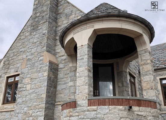 Photo of Dusty Rose Square and Rectangle Natural Thin Stone Veneer installed on a residential entry tower.