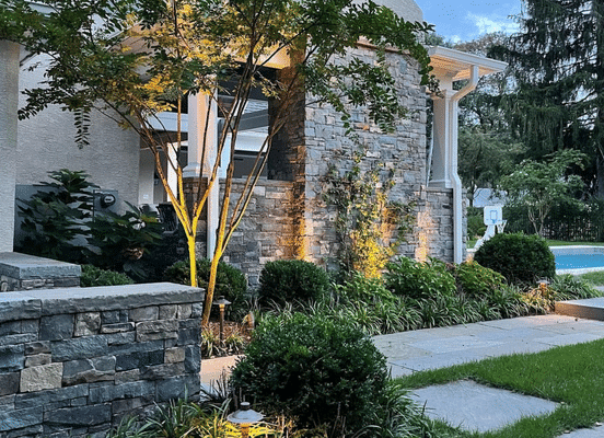 Photo of Fieldstone Dark Ashlar Natural Thin Stone Veneer installed on landscape walls and entryway features.