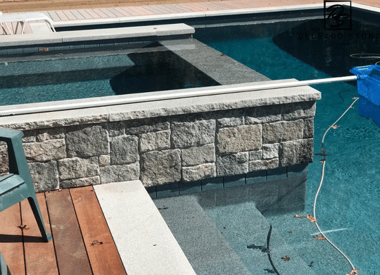 Greenwich Blue natural stone veneer poolside wall installation