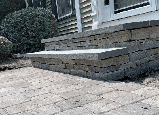 Photo of Liberty Hill Ledge Natural Thin Stone Veneer installed on retaining walls and outdoor steps.