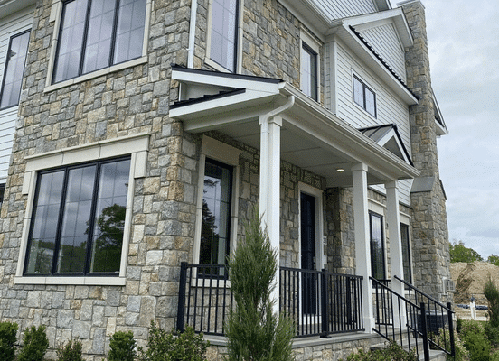 Photo of New York Blend Square and Rectangle Natural Thin Stone Veneer installed on a residential exterior facade.
