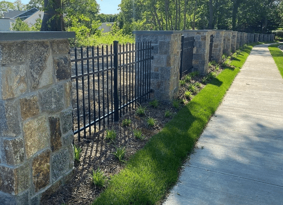Photo of New York Blend Square and Rectangle Natural Thin Stone Veneer installed on fence columns and landscape walls.