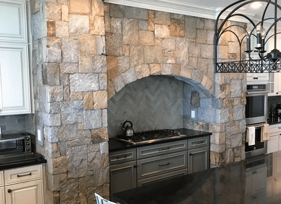 Photo of Nutmeg Ridge Square and Rectangle Natural Thin Stone Veneer installed on an indoor kitchen arch surround.