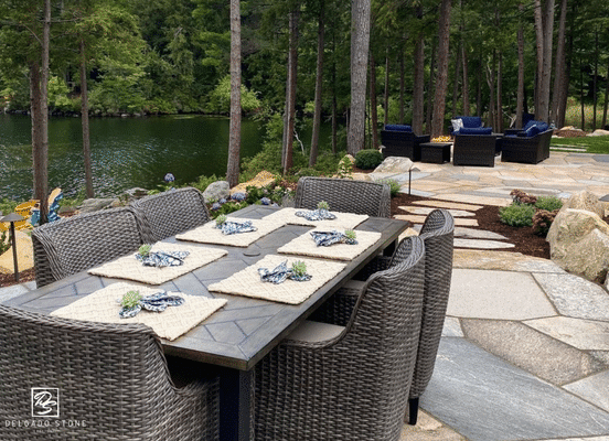 Old New England Wall sawn flagstone outdoor dining patio surrounded by natural landscape.