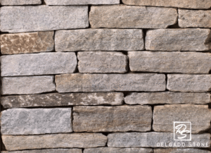 Spruce Mountain Ledge stone veneer swatch showcasing stacked stone texture and natural earth tones.