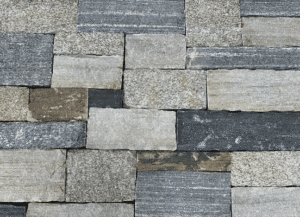 Photo of Taconic Ridge Ashlar Natural Thin Stone Veneer swatch showcasing a blend of grey, charcoal, and cream stone tones.