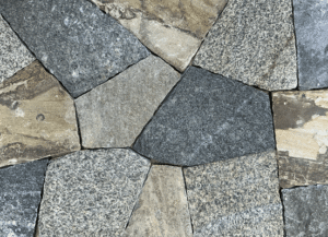 Photo of Taconic Ridge Mosaic Natural Thin Stone Veneer swatch displaying irregular stone shapes with grey, tan, and charcoal tones.