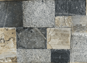 Photo of Taconic Ridge Square and Rectangle Natural Thin Stone Veneer swatch showcasing natural grey, cream, and charcoal stone tones.