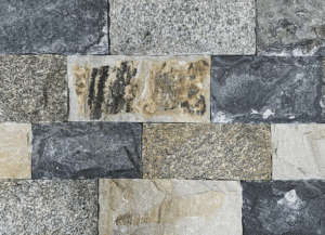 Photo of Taconic Ridge Strip Natural Thin Stone Veneer swatch featuring linear stone pieces with blended grey and cream color variation.