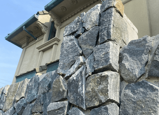 Photo of American Mist Mosaic stone veneer by Delgado Stone featured on a premium stone wall, highlighting natural stone veneer craftsmanship, outdoor living aesthetics, and timeless New England character.