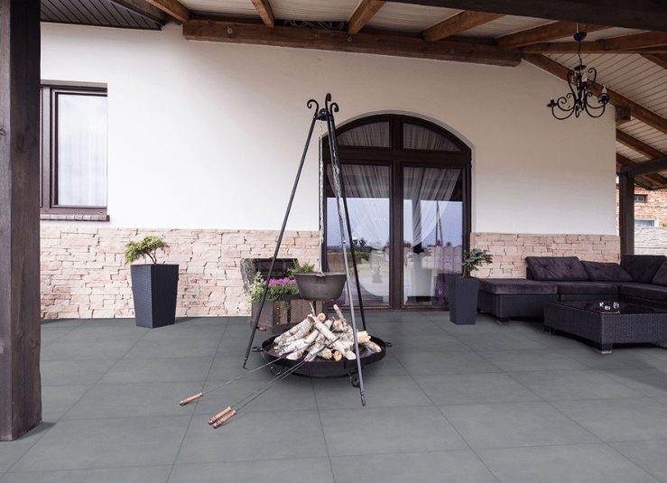 Covered patio with Arterra True Blue porcelain pavers and outdoor seating