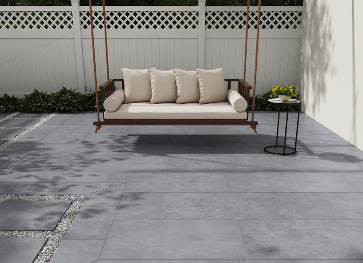 Backyard swing area with Arterra True Blue porcelain pavers and stepping stones